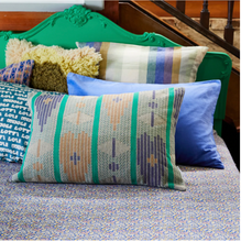 Load image into Gallery viewer, Geometric seasonal coloured cushion styled on bed
