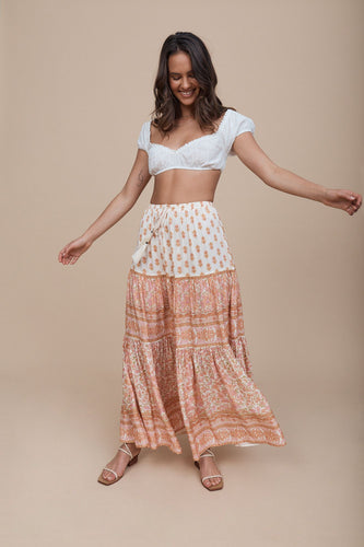 Model wearing white & coral floral printed skirt.